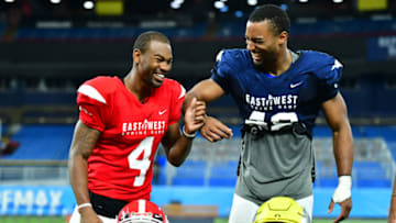 ST PETERSBURG, FLORIDA - JANUARY 19: Terry Godwin II #4 from Georgia playing on the East Team and Justin Hollins #48 from Oregon playing on the West Team joke around before accepting the offensive and defensive MVP at the 2019 East-West Shrine Game at Tropicana Field on January 19, 2019 in St Petersburg, Florida. (Photo by Julio Aguilar/Getty Images)
