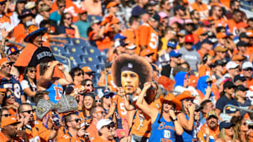 DENVER, CO - SEPTEMBER 29: Colorful and costumed broncos fans including one woman holding a large picture of the face of Phillip Lindsay #30 of the Denver Broncos cheer during the second quarter of a game against the Jacksonville Jaguars at Empower Field at Mile High on September 29, 2019 in Denver, Colorado. (Photo by Dustin Bradford/Getty Images)