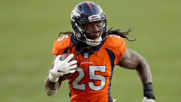 DENVER, COLORADO - NOVEMBER 22: Melvin Gordon #25 of the Denver Broncos carries the ball for a touchdown against the Miami Dolphins, to take a 20-10, during the third quarter at Empower Field At Mile High on November 22, 2020 in Denver, Colorado. (Photo by Matthew Stockman/Getty Images)