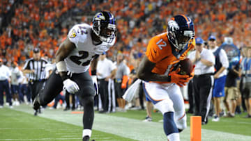 DENVER, CO - SEPTEMBER 5: Andre Caldwell #12 of the Denver Broncos catches a 28-yard pass before running in for the touchdown in front of Jimmy Smith #22 of the Baltimore Ravens in the third quarter during the game at Sports Authority Field at Mile High on September 5, 2013 in Denver Colorado. (Photo by Dustin Bradford/Getty Images)