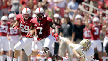 PALO ALTO, CA - AUGUST 30: Ty Montgomery #7 of the Stanford Cardinal goes past Colby Wadman #15 of the UC Davis Aggies on his way to returning a punt for a touchdown at Stanford Stadium on August 30, 2014 in Palo Alto, California. (Photo by Ezra Shaw/Getty Images)