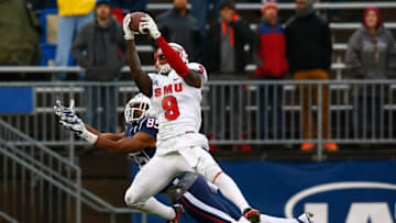 EAST HARTFORD, CT - DECEMBER 06: Horace Richardson #9 of the SMU Mustangs intercepts a pass in front of Geremy Davis #85 of the Connecticut Huskies in the second quarter during the game at Rentschler Field on December 6, 2014 in East Hartford, Connecticut. (Photo by Jared Wickerham/Getty Images)