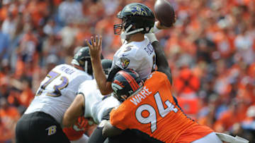 DENVER, CO - SEPTEMBER 13: Quarterback Joe Flacco #5 of the Baltimore Ravens passes and takes a hit from linebacker DeMarcus Ware #94 of the Denver Broncos in the first quarter of a game at Sports Authority Field at Mile High on September 13, 2015 in Denver, Colorado. (Photo by Dustin Bradford/Getty Images)