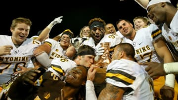FORT COLLINS, CO - OCTOBER 1: The Wyoming Cowboys celebrate with The Bronze Boot after winning the border war against Colorado State Rams 38-17 at Sonny Lubick Field at Hughes Stadium on October 1, 2016 in Fort Collins, Colorado. (Photo by Justin Edmonds/Getty Images)