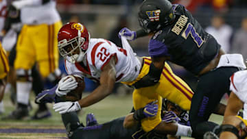 SEATTLE, WA - NOVEMBER 12: Running back Justin Davis #22 of the USC Trojans is tackled by linebacker Keishawn Bierria #7 of the Washington Huskies on November 12, 2016 at Husky Stadium in Seattle, Washington. The Trojans defeated the Huskies 24-13. (Photo by Otto Greule Jr/Getty Images)