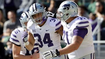 WACO, TX - NOVEMBER 19: Alex Barnes #34 of the Kansas State Wildcats celebrates his touchdown with Dalton Risner #71 of the Kansas State Wildcats against the Baylor Bears at McLane Stadium on November 19, 2016 in Waco, Texas. (Photo by Ronald Martinez/Getty Images)