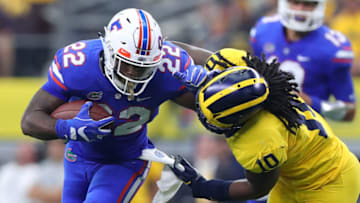 ARLINGTON, TX - SEPTEMBER 02: Lamical Perine #22 of the Florida Gators holds off Devin Bush #10 of the Michigan Wolverines on a carry in the second quarter of a game at AT&T Stadium on September 2, 2017 in Arlington, Texas. (Photo by Tom Pennington/Getty Images)