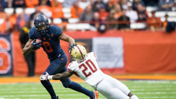 SYRACUSE, NY - NOVEMBER 25: Steve Ishmael #8 of the Syracuse Orange carries the ball while fending off Isaac Yiadom #20 of the Boston College Eagles during the second half at the Carrier Dome on November 25, 2017 in Syracuse, New York. Boston College defeats Syracuse 42-14. (Photo by Brett Carlsen/Getty Images)