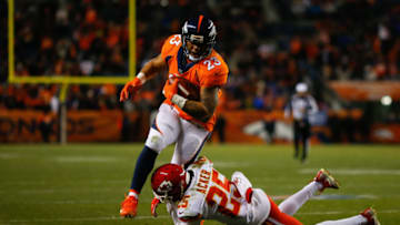 DENVER, CO - DECEMBER 31: Running back Devontae Booker #23 of the Denver Broncos is tackled by cornerback Kenneth Acker #25 of the Kansas City Chiefs during the fourth quarter at Sports Authority Field at Mile High on December 31, 2017 in Denver, Colorado. The Chiefs defeated the Broncos 27-24. (Photo by Justin Edmonds/Getty Images)
