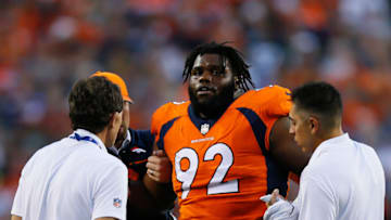 DENVER, CO - AUGUST 26: nose tackle Zach Kerr #92 of the Denver Broncos is helped off the field by the training staff in the first quarter during a Preseason game against the Green Bay Packers at Sports Authority Field at Mile High on August 26, 2017 in Denver, Colorado. (Photo by Justin Edmonds/Getty Images)