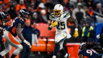 DENVER, CO - DECEMBER 1: Melvin Gordon #25 of the Los Angeles Chargers rushes against the Denver Broncos in the fourth quarter of a game at Empower Field at Mile High on December 1, 2019 in Denver, Colorado. (Photo by Dustin Bradford/Getty Images)