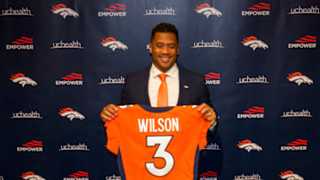 ENGLEWOOD, CO - MARCH 16: Quarterback Russell Wilson #3 of the Denver Broncos poses with his jersey after speaking to the media at UCHealth Training Center on March 16, 2022 in Englewood, Colorado. (Photo by Justin Edmonds/Getty Images)