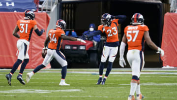 DENVER, COLORADO - NOVEMBER 29: Essang Bassey #34 of the Denver Broncos celebrates with Michael Ojemudia during an NFL game against the New Orleans Saints, Sunday, Nov. 29, 2020, in Denver. (Photo by Cooper Neill/Getty Images)
