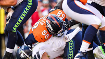 DENVER, CO - SEPTEMBER 9: Quarterback Russell Wilson #3 of the Seattle Seahawks is hit by linebacker Von Miller #58 of the Denver Broncos after recovering a fumble off of a bad snap in the fourth quarter of at Broncos Stadium at Mile High on September 9, 2018 in Denver, Colorado. (Photo by Dustin Bradford/Getty Images)