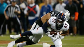 OAKLAND, CALIFORNIA - SEPTEMBER 09: Noah Fant #87 of the Denver Broncos is tackled for a loss by Josh Mauro #97 of the Oakland Raiders in the first quarter of the game at RingCentral Coliseum on September 09, 2019 in Oakland, California. (Photo by Lachlan Cunningham/Getty Images)