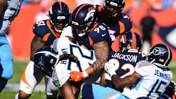 Oct 13, 2019; Denver, CO, USA; Denver Broncos nose tackle Mike Purcell (98) stops Tennessee Titans running back Derrick Henry (22) in the second quarter at Empower Field at Mile High. Mandatory Credit: Ron Chenoy-USA TODAY Sports