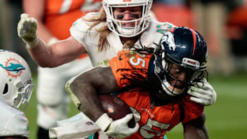 Nov 22, 2020; Denver, Colorado, USA; Denver Broncos running back Melvin Gordon III (25) is pulled down by Miami Dolphins linebacker Andrew Van Ginkel (43) in the fourth quarter at Empower Field at Mile High. Mandatory Credit: Isaiah J. Downing-USA TODAY Sports