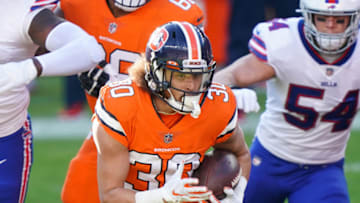 Dec 19, 2020; Denver, Colorado, USA; Denver Broncos running back Phillip Lindsay (30) runs against Buffalo Bills linebacker A.J. Klein (54) during the first quarter at Empower Field at Mile High. Mandatory Credit: Troy Babbitt-USA TODAY Sports