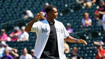 Aug 22, 2021; Denver, Colorado, USA; Denver Bronco cornerback Patrick Surtain II throws the first pitch before the game between the Colorado Rockies against the Arizona Diamondbacks at Coors Field. Mandatory Credit: Ron Chenoy-USA TODAY Sports