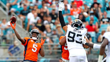 Sep 19, 2021; Jacksonville, Florida, USA; Denver Broncos quarterback Teddy Bridgewater (5) throws a pass against Jacksonville Jaguars defensive linemen Taven Bryan (93) during the second quarter at TIAA Bank Field. Mandatory Credit: Mark J. Rebilas-USA TODAY Sports