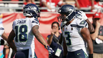 Oct 3, 2021; Santa Clara, California, USA; Seattle Seahawks wide receiver Freddie Swain (18) celebrates with Seattle Seahawks quarterback Russell Wilson (3) after scoring a touchdown during the third quarter against the San Francisco 49ers at Levi's Stadium. Mandatory Credit: Darren Yamashita-USA TODAY Sports