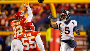 Dec 5, 2021; Kansas City, Missouri, USA; Denver Broncos quarterback Teddy Bridgewater (5) throws a pass as Kansas City Chiefs safety Tyrann Mathieu (32) and defensive end Frank Clark (55) defend during the first half at GEHA Field at Arrowhead Stadium. Mandatory Credit: Jay Biggerstaff-USA TODAY Sports