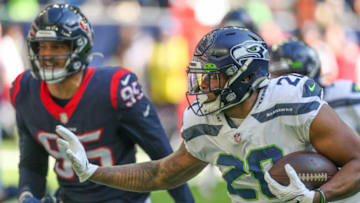 Dec 12, 2021; Houston, Texas, USA; Seattle Seahawks running back Rashaad Penny (20) rushes against Houston Texans defensive end Derek Rivers (95) in the first quarter at NRG Stadium. Mandatory Credit: Thomas Shea-USA TODAY Sports