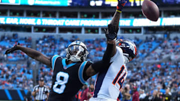 Nov 27, 2022; Charlotte, North Carolina, USA; Carolina Panthers cornerback Jaycee Horn (8) breaks up a pass intended for Denver Broncos wide receiver Courtland Sutton (14) in the fourth quarter at Bank of America Stadium. Mandatory Credit: Bob Donnan-USA TODAY Sports