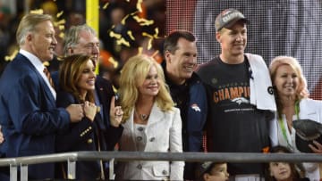 Feb 7, 2016; Santa Clara, CA, USA; Denver Broncos quarterback Peyton Manning poses with head coach Gary Kubiak and the Vince Lombardi Trophy presenters after the game against the Carolina Panthers in Super Bowl 50 at Levi's Stadium. The Broncos won 24-10. Mandatory Credit: Kyle Terada-USA TODAY Sports