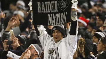 Dec 24, 2018; Oakland, CA, USA; An Oakland Raiders fan holds a towel reading "raider nation" during the fourth quarter against the Denver Broncos at Oakland Coliseum. Mandatory Credit: Kelley L Cox-USA TODAY Sports