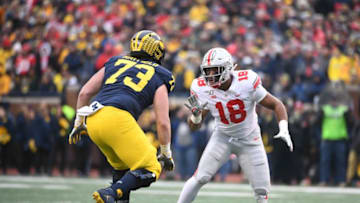 Nov 30, 2019; Ann Arbor, MI, USA; Ohio State Buckeyes defensive end Jonathon Cooper (18) battle for position with Michigan Wolverines offensive lineman Jalen Mayfield (73) at Michigan Stadium. Mandatory Credit: Tim Fuller-USA TODAY Sports