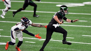 New York Jets quarterback Sam Darnold (14) breaks a tackle by Denver Broncos safety Justin Simmons (31) on his way to a touchdown in the first quarter at MetLife Stadium on Thursday, Oct. 1, 2020, in East Rutherford.Nfl Jets Broncos