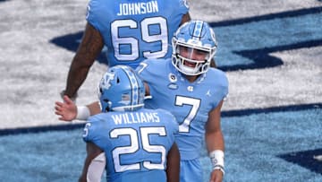 Oct 24, 2020; Chapel Hill, North Carolina, USA; North Carolina Tar Heels running back Javonte Williams (25) celebrates with quarterback Sam Howell (7) after scoring a touchdown in the fourth quarter at Kenan Memorial Stadium. Mandatory Credit: Bob Donnan-USA TODAY Sports