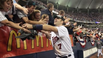 MINNEAPOLIS - OCTOBER 06: Joe Mauer #7 of the Minnesota Twins celebrates with fans after winning the American League tiebreaker game against the Detroit Tigers on October 6, 2009 at Hubert H. Humphrey Metrodome in Minneapolis, Minnesota. (Photo by Jamie Squire/Getty Images)