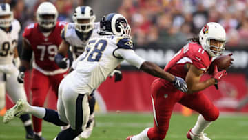 GLENDALE, ARIZONA - DECEMBER 23: Wide receiver Larry Fitzgerald #11 of the Arizona Cardinals runs with the football after a reception against inside linebacker Cory Littleton #58 of the Los Angeles Rams during the first half NFL game at State Farm Stadium on December 23, 2018 in Glendale, Arizona. (Photo by Christian Petersen/Getty Images)