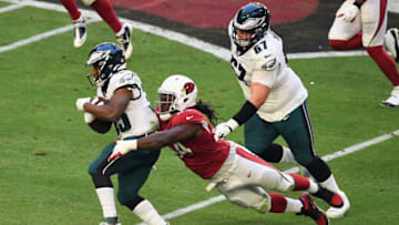 GLENDALE, ARIZONA - DECEMBER 20: Boston Scott #35 of the Philadelphia Eagles breaks a tackle from Markus Golden #44 of the Arizona Cardinals during the second quarter at State Farm Stadium on December 20, 2020 in Glendale, Arizona. (Photo by Norm Hall/Getty Images)