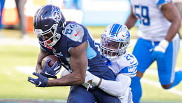 NASHVILLE, TENNESSEE - Wide receiver Corey Davis #84 of the Tennessee Titans talks is tackled by cornerback Amani Oruwariye #24 of the Detroit Lions at Nissan Stadium on December 20, 2020 in Nashville, Tennessee. The Titans defeated the Lions 46-25. (Photo by Wesley Hitt/Getty Images)