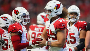 Jan 1, 2023; Atlanta, Georgia, USA; Arizona Cardinals defensive tackle Leki Fotu (95) celebrates with linebacker Isaiah Simmons (9) after a fumble recovery against the Atlanta Falcons in the first half at Mercedes-Benz Stadium. Mandatory Credit: Brett Davis-USA TODAY Sports