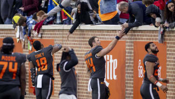 Jan 30, 2021; Mobile, AL, USA; National defensive lineman Shaka Toney of Penn State (18), wide receiver Frank Darby of Arizona State (84) and other players greet fans after the 2021 Senior Bowl at Hancock Whitney Stadium. Mandatory Credit: Vasha Hunt-USA TODAY Sports