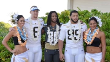 Jan 29, 2016; Kahuku, HI, USA; Los Angeles Rams players Todd Gurley (30), Aaron Donald (99) and Johnny Hekker (6) pose with hula girls Chelsea Hardin (left) and Mahina Garcia (right) during 2016 Pro Bowl photo day at Turtle Bay Resort. Mandatory Credit: Kirby Lee-USA TODAY Sports