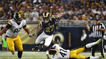 Sep 27, 2015; St. Louis, MO, USA; St. Louis Rams running back Tre Mason (27) leaps over Pittsburgh Steelers cornerback Antwon Blake (41) during the second half at the Edward Jones Dome. Steelers defeated the Rams 12-6. Mandatory Credit: Jeff Curry-USA TODAY Sports