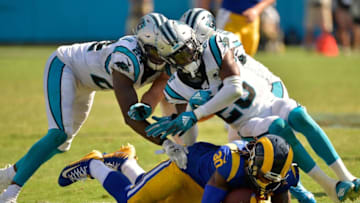 CHARLOTTE, NORTH CAROLINA - SEPTEMBER 08: James Bradberry #24 and Rashaan Gaulden #28 of the Carolina Panthers tackle Todd Gurley #30 of the Los Angeles Rams during the fourth quarter of their game at Bank of America Stadium on September 08, 2019 in Charlotte, North Carolina. The Rams won 30-23,. (Photo by Grant Halverson/Getty Images)