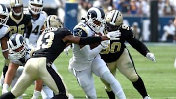 LOS ANGELES, CALIFORNIA - SEPTEMBER 15: Todd Gurley #30 of the Los Angeles Rams runs the ball against Marcus Williams #43 and Malcom Brown #90 of the New Orleans Saints during the first half at Los Angeles Memorial Coliseum on September 15, 2019 in Los Angeles, California. (Photo by Kevork Djansezian/Getty Images)