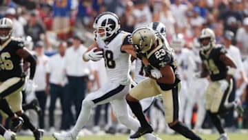 LOS ANGELES, CALIFORNIA - SEPTEMBER 15: Cooper Kupp #18 of the Los Angeles Rams runs on a 67-yard reception during the fourth quarter as Marshon Lattimore #23 of the New Orleans Saints attempts to tackle him in the game at Los Angeles Memorial Coliseum on September 15, 2019 in Los Angeles, California. (Photo by Sean M. Haffey/Getty Images)