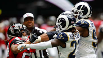 ATLANTA, GEORGIA - OCTOBER 20: Devonta Freeman #24 of the Atlanta Falcons throws a punch as he scuffles with Aaron Donald #99 of the Los Angeles Rams in the second half at Mercedes-Benz Stadium on October 20, 2019 in Atlanta, Georgia. (Photo by Kevin C. Cox/Getty Images)