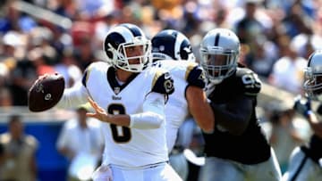 LOS ANGELES, CA - AUGUST 18: Brandon Allen #8 of the Los Angeles Rams looks to pass as Fadol Brown #95 of the Oakland Raiders defends during the second half of a preseason game at Los Angeles Memorial Coliseum on August 18, 2018 in Los Angeles, California. (Photo by Sean M. Haffey/Getty Images)