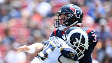 LOS ANGELES, CA - AUGUST 25: Brandon Weeden #3 of the Houston Texans throws an interception as he is hit by Ethan Westbrooks #95 of the Los Angeles Rams during the first quarter of a preseason game at Los Angeles Memorial Coliseum on August 25, 2018 in Los Angeles, California. (Photo by Harry How/Getty Images)