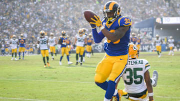 LOS ANGELES, CA - OCTOBER 28: Running back Todd Gurley #30 of the Los Angeles Rams completes a pass in front of defensive back Jermaine Whitehead #35 of the Green Bay Packers in the second quarter at Los Angeles Memorial Coliseum on October 28, 2018 in Los Angeles, California. (Photo by John McCoy/Getty Images)