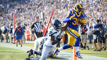 LOS ANGELES, CA - NOVEMBER 11: Running back Todd Gurley #30 of the Los Angeles Rams scores a touchdown in front of defensive end Dion Jordan #95 of the Seattle Seahawks to take a 17-14 lead in the second quarter at Los Angeles Memorial Coliseum on November 11, 2018 in Los Angeles, California. (Photo by Harry How/Getty Images)
