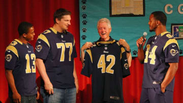 ST. LOUIS, MO - APRIL 7: Chris Givens #13, Jake Long #77 and Robert Quinn #94 all of the St. Louis Rams present former President Bill Clinton with a Rams jersey during the Clinton Global Initiative University at Gateway STEM High School on April 7, 2013 in St Louis Missouri. (Photo by Dilip Vishwanat/Getty Images)